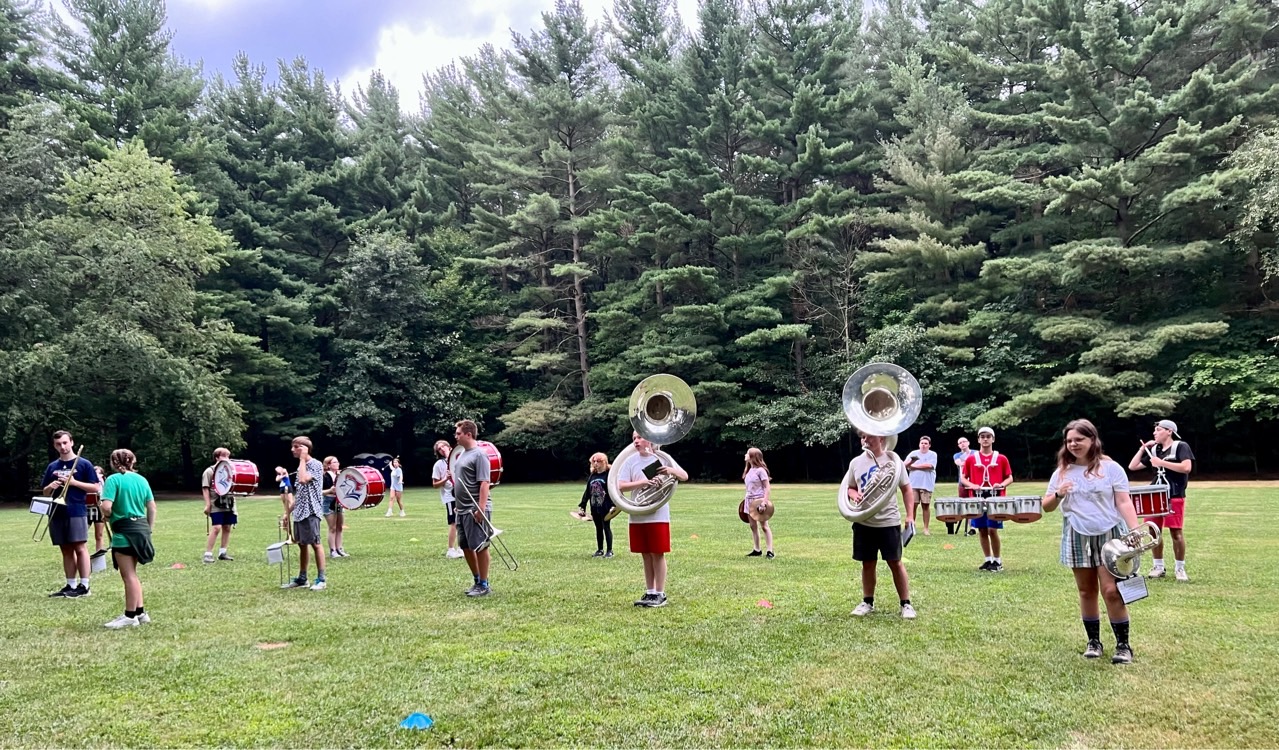 Various band members practicing on the practice field.